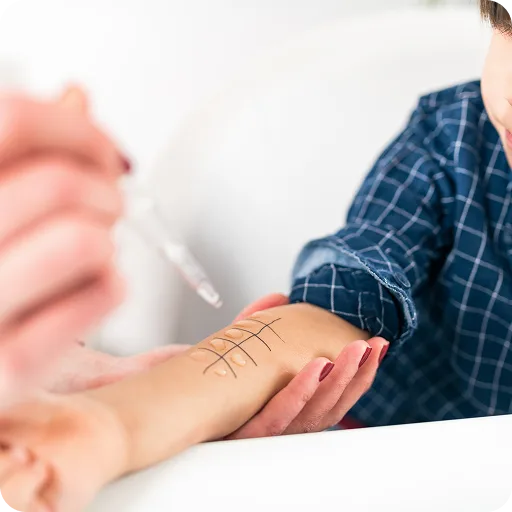 Doctor examining a rash on a child's arm