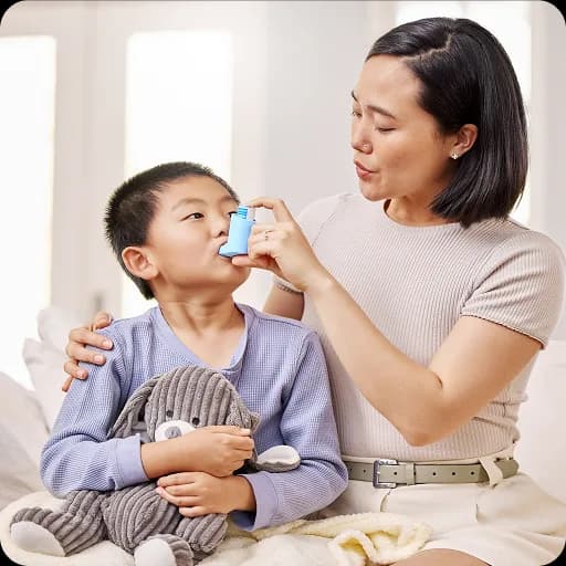 Mother helping a child use an inhaler with a spacer