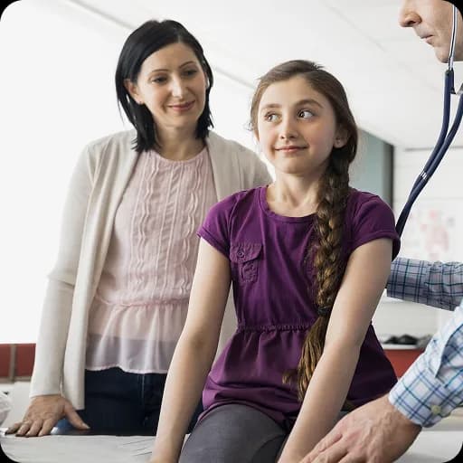 Teenage girl with her mother being examined