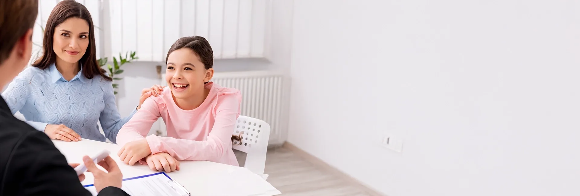 Teenage girl and mother talking with a doctor