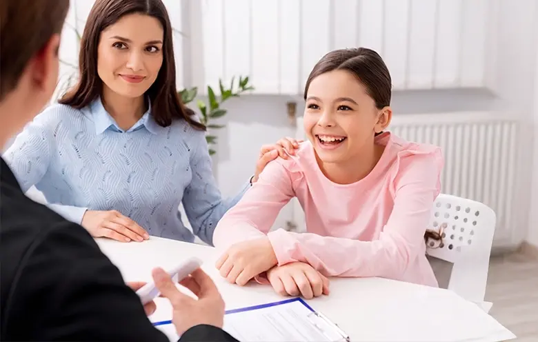 Teenage girl and mother talking with a doctor