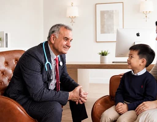Paediatrician talking with a young boy