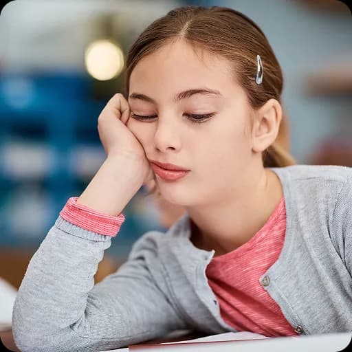 Girl resting her head on her hand looking tired