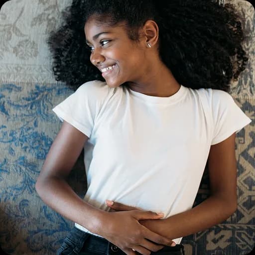 Teenage girl sitting on a bed