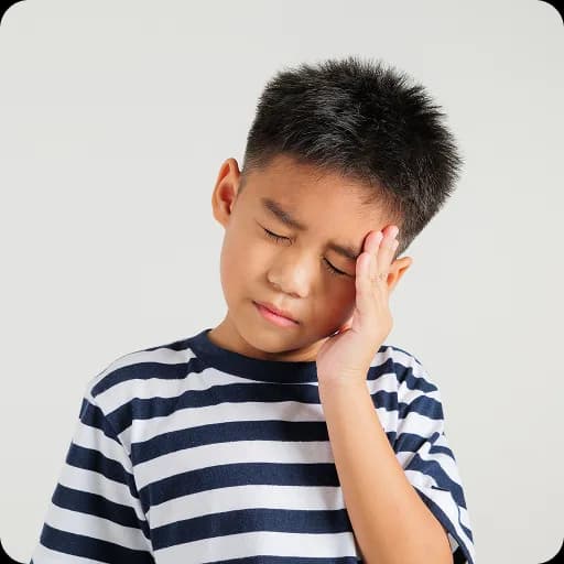 Boy holding his head looking worried