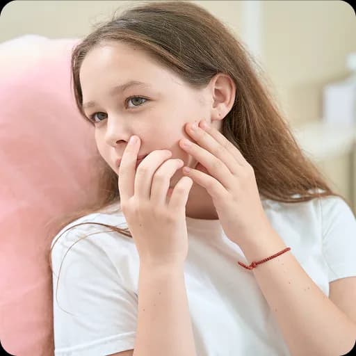 Girl touching a spot on her cheek