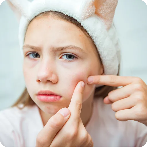 Young girl looking at a spot on her face