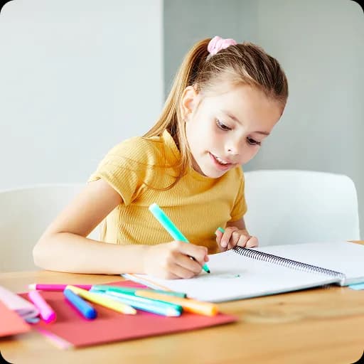 Young girl drawing at a table