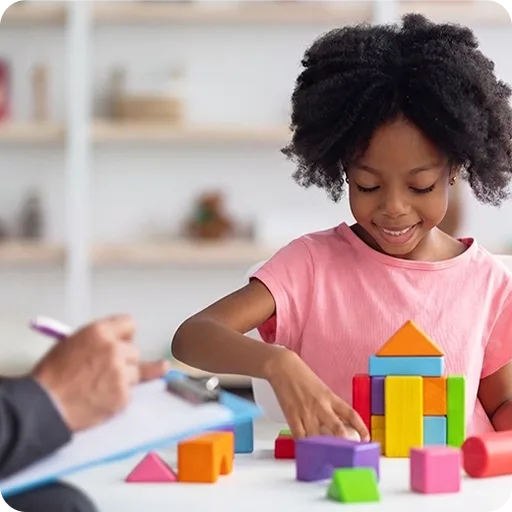 Young girl playing with building blocks
