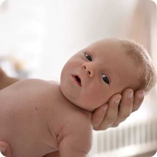 Baby being held in an adult's hands