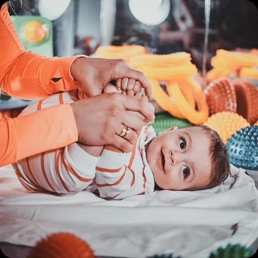 Baby lying on a colourful play mat