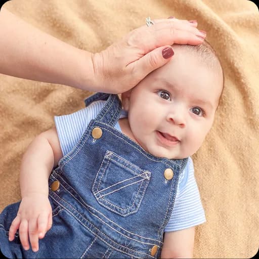 Smiling baby in dungarees