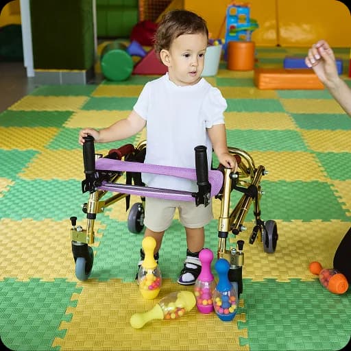 Child using a walking frame on a play mat