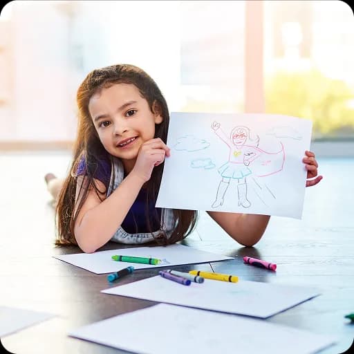 Girl holding up a drawing