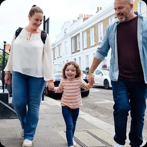 Parents walking with a young child outdoors
