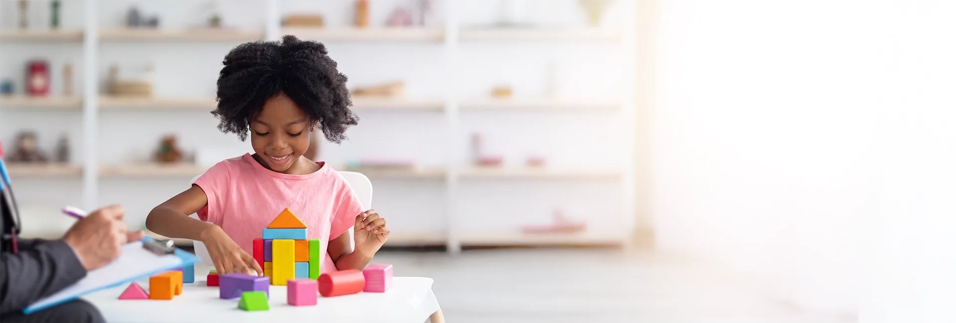 Young girl playing with building blocks