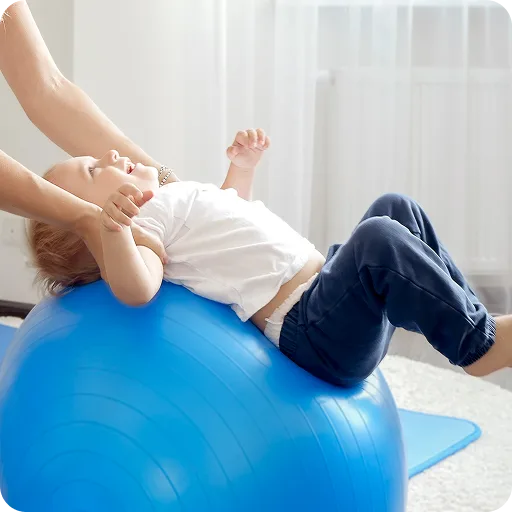 Child lying on an exercise ball