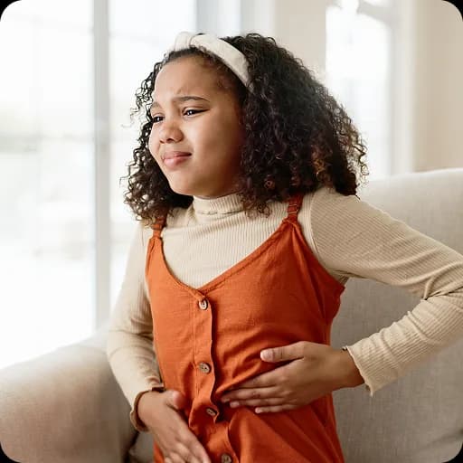 Girl sitting with her hands on her tummy