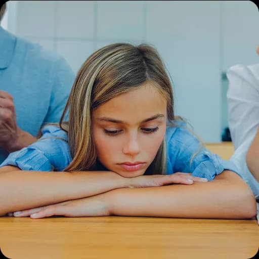 Teenage girl resting her head on a desk