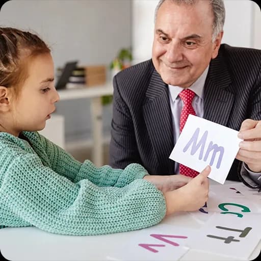 Paediatrician showing a card to a young girl