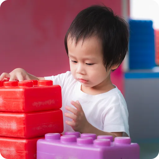 Toddler playing with building blocks
