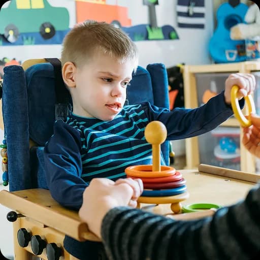 Toddler playing with toys in a high chair
