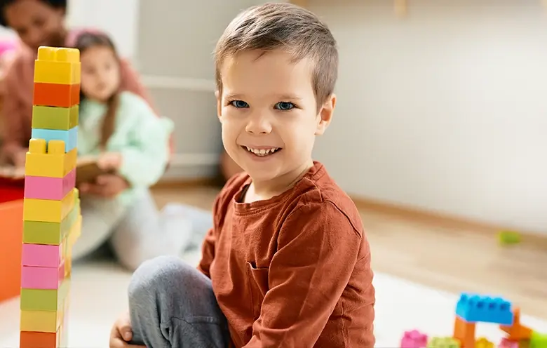 Young boy playing with building blocks