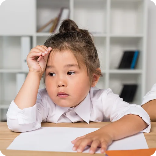 Young girl at a desk looking worried