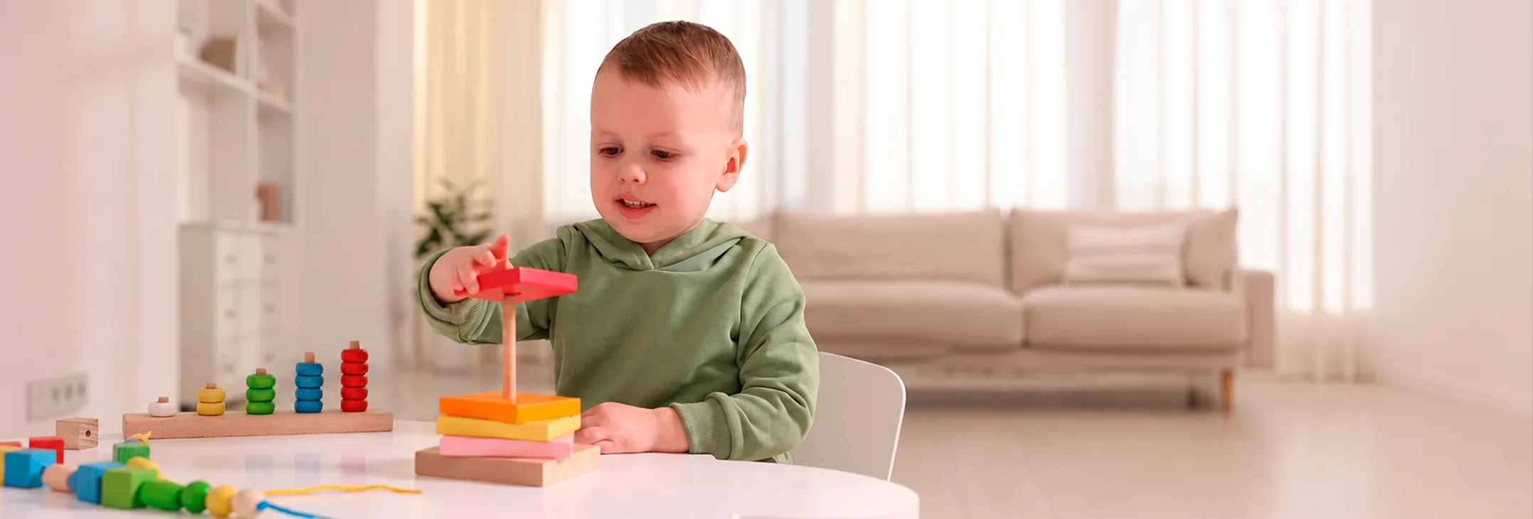 Toddler playing with a stacking toy at home