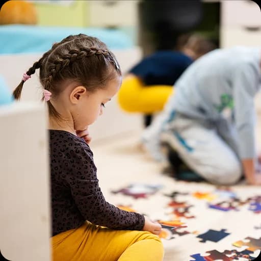 Young girl playing with puzzle pieces