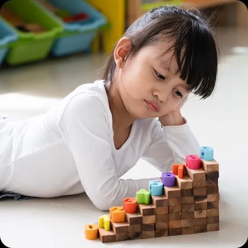 Young girl stacking colourful blocks