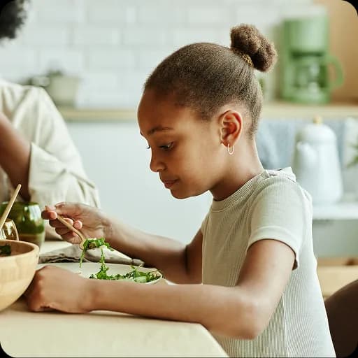 Girl eating a meal at a table
