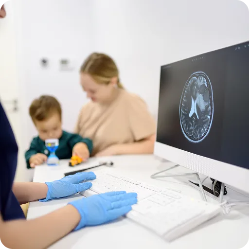 Child having an EEG test at a computer