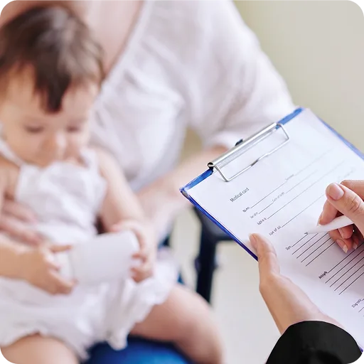 Doctor with a clipboard beside a baby