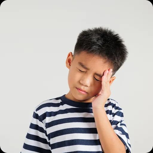 Boy resting his head on his hand looking worried