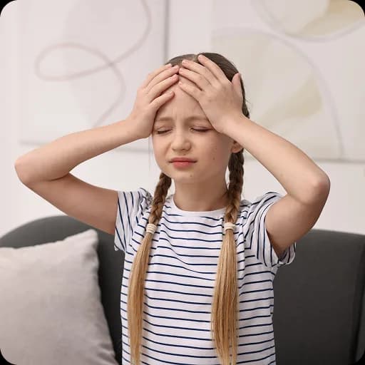 Girl holding her head in pain