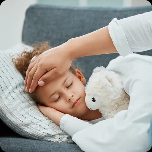 Mother checking a sick child's temperature in bed