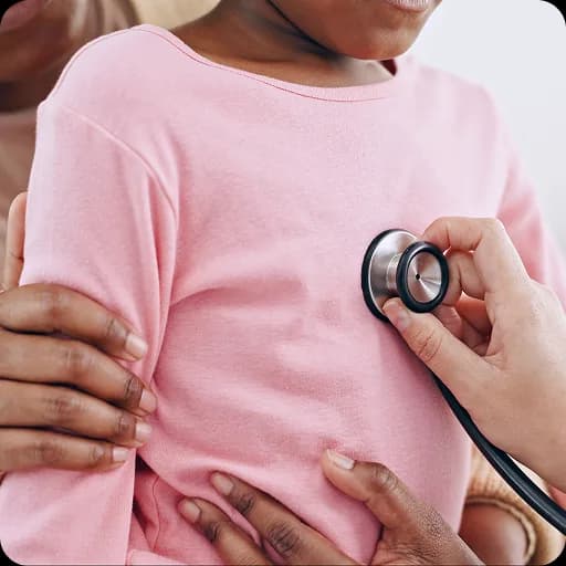 Doctor listening to a girl's chest with a stethoscope