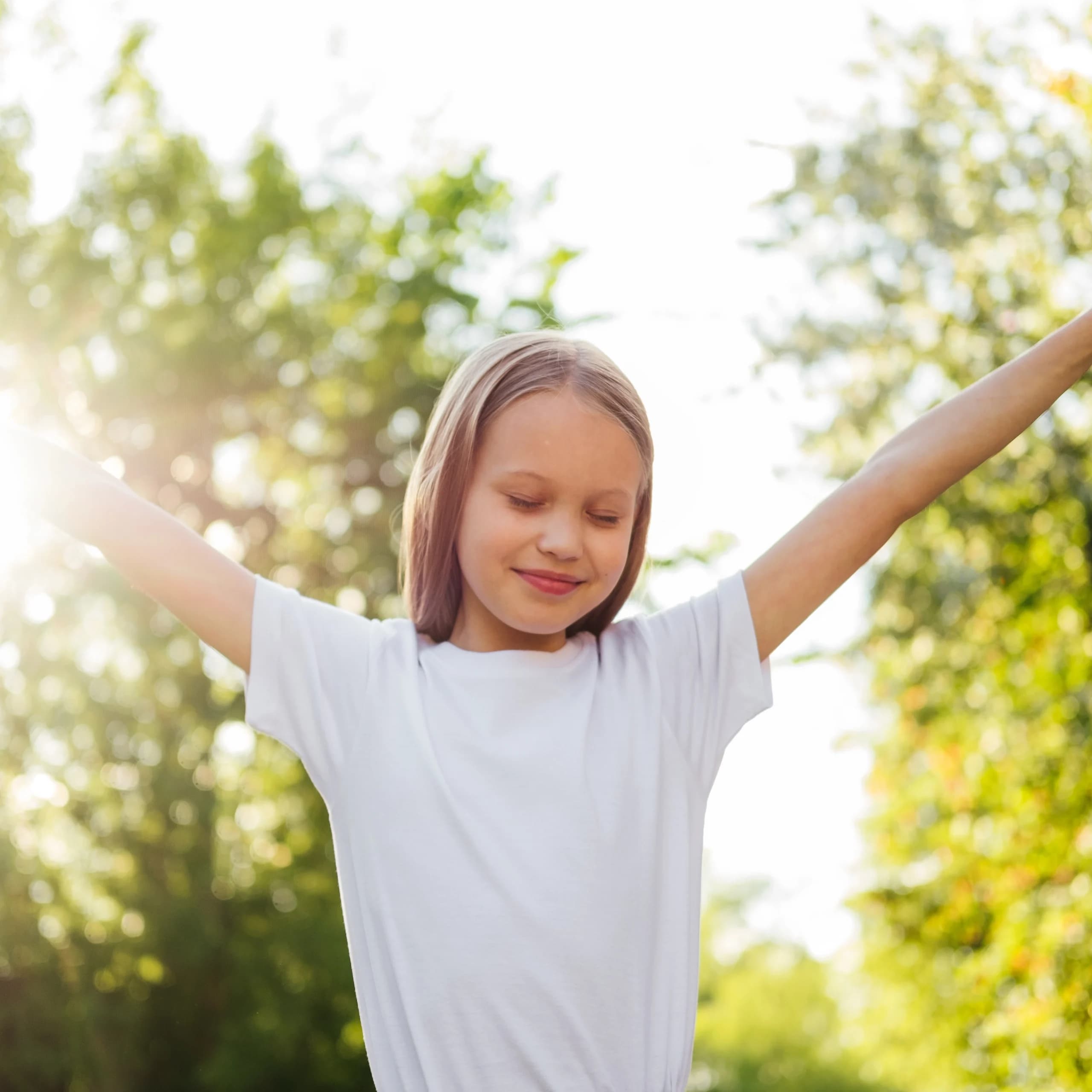 Child playing outdoors in the sunshine