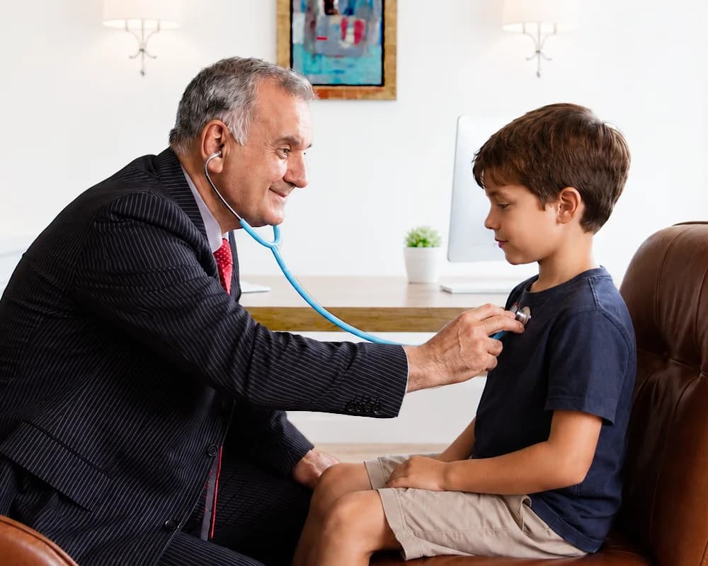 Paediatrician examining a child at home