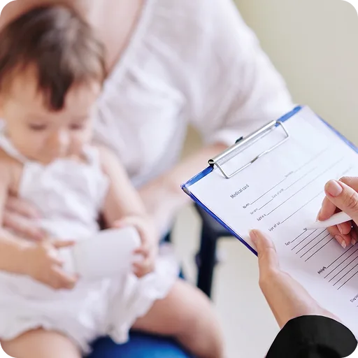 Doctor with a clipboard beside a baby