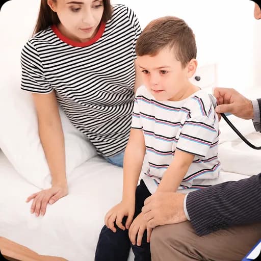 Doctor examining a young boy