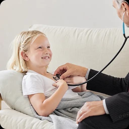 Doctor listening to a girl's chest with a stethoscope