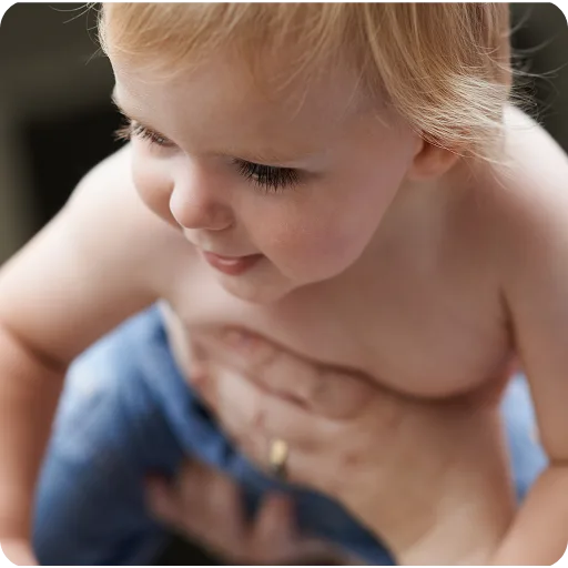 Baby being held by an adult