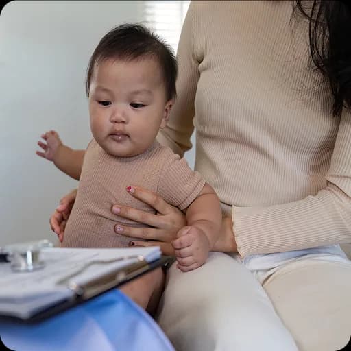 Mother holding a baby during a consultation