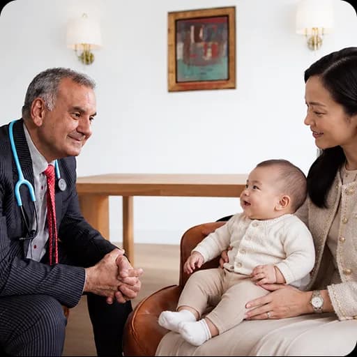 Paediatrician with a mother and baby