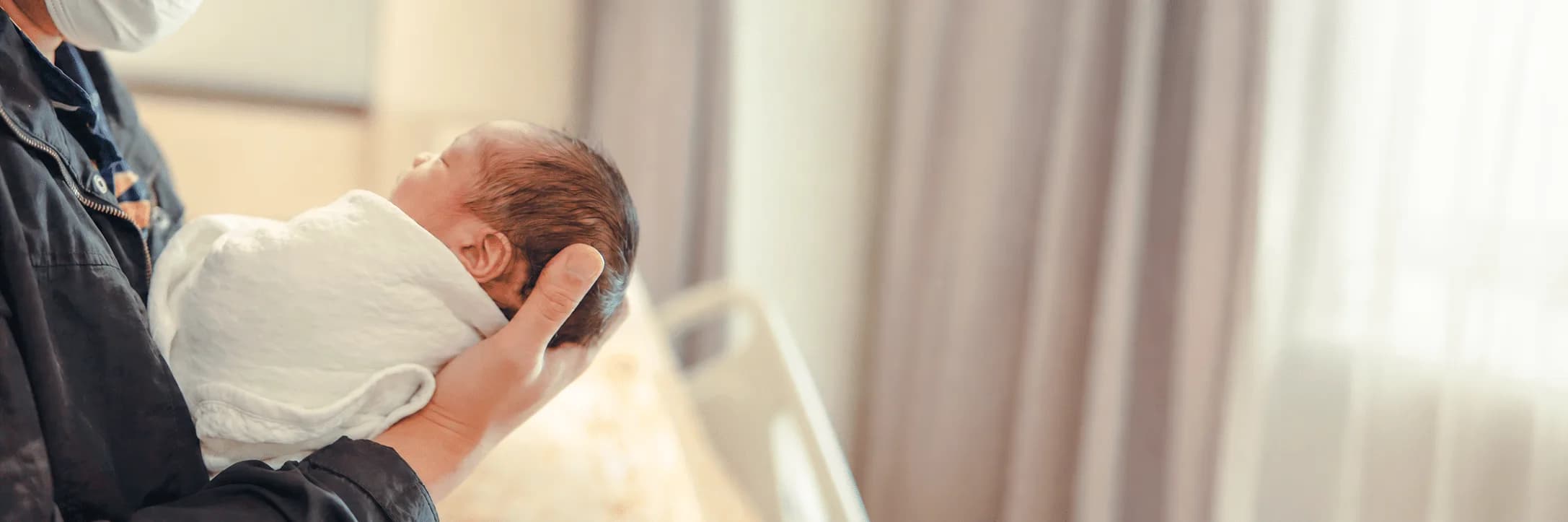 Parent holding a newborn baby