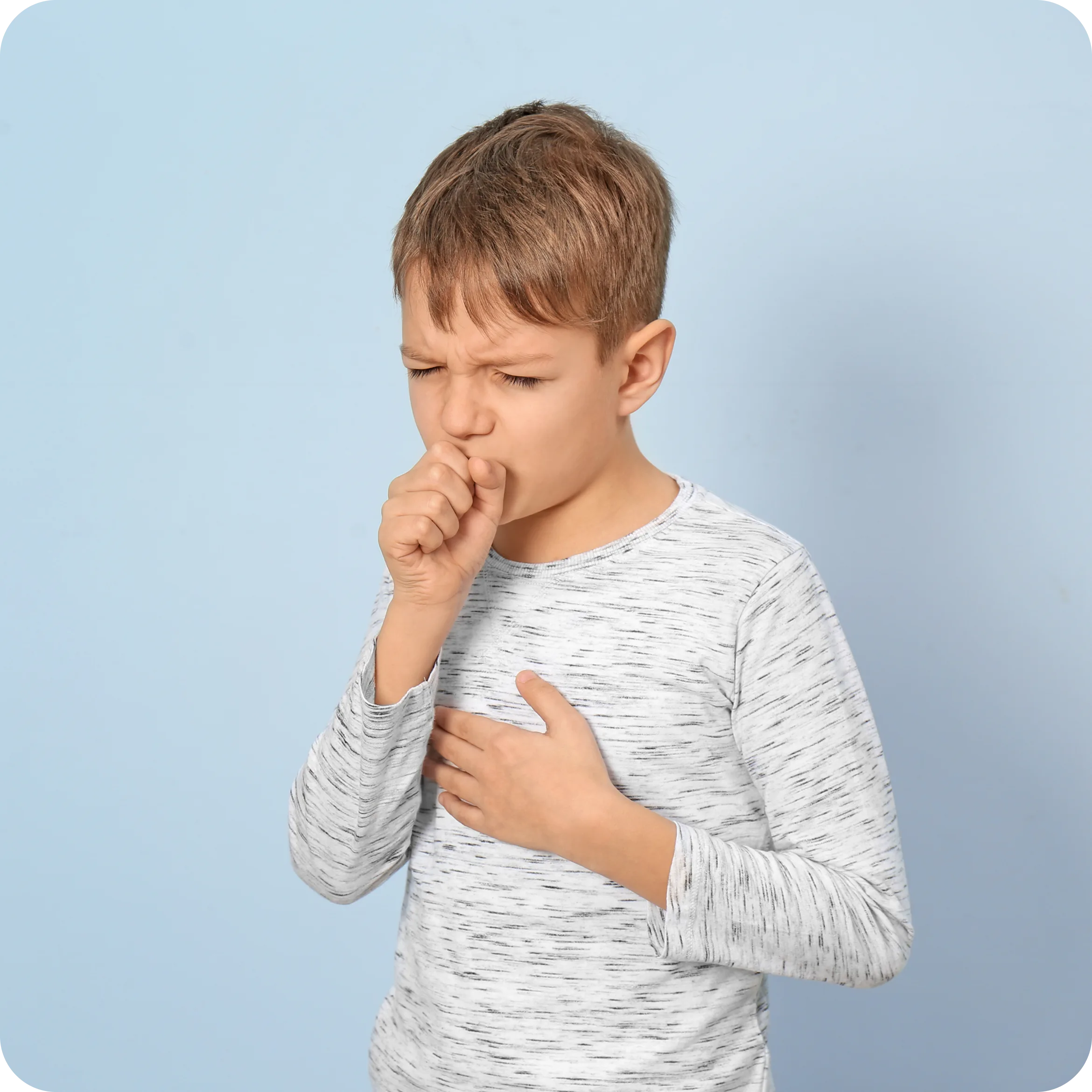 Boy coughing into his hand