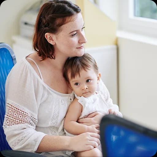 Mother holding a baby at home