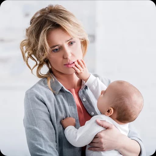 Mother holding a baby looking tired